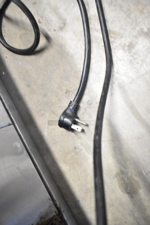 Close-up of power cord for 2023 Treu GDM-26-HC commercial cooler, 115 volts, single phase, in good condition.