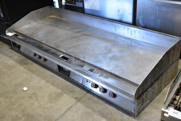 Stainless steel commercial countertop flat top griddle with thermostatic controls. Used condition, visible wear.