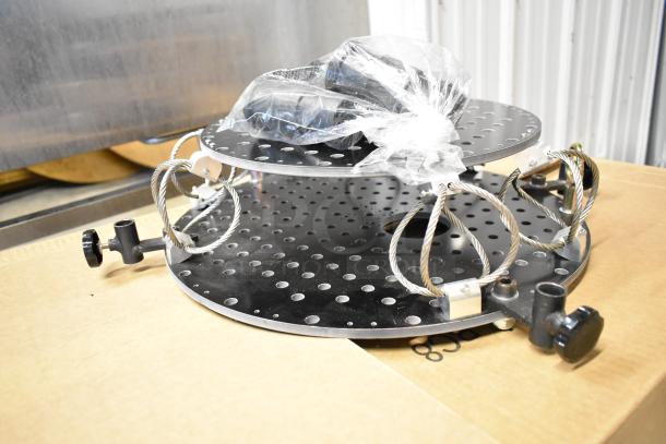 Perforated 2 Tier Unit with circular metal shelves, cable supports, and adjustment knobs. New, packaged in plastic.