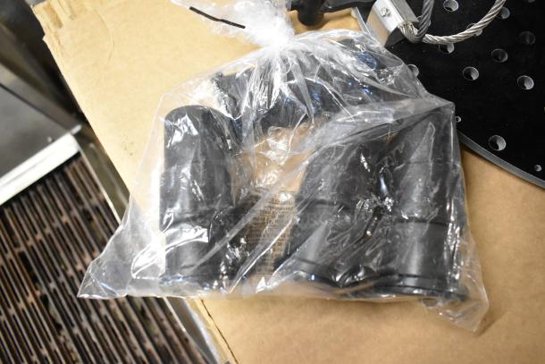 Perforated 2 Tier Unit with metal construction, visible perforations. Includes bundled black rubber pieces in sealed plastic bag.