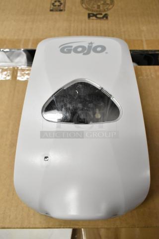 Box of 15 Gojo wall-mounted poly soap dispensers, featuring a white exterior and Gojo logo. Ideal for commercial use.