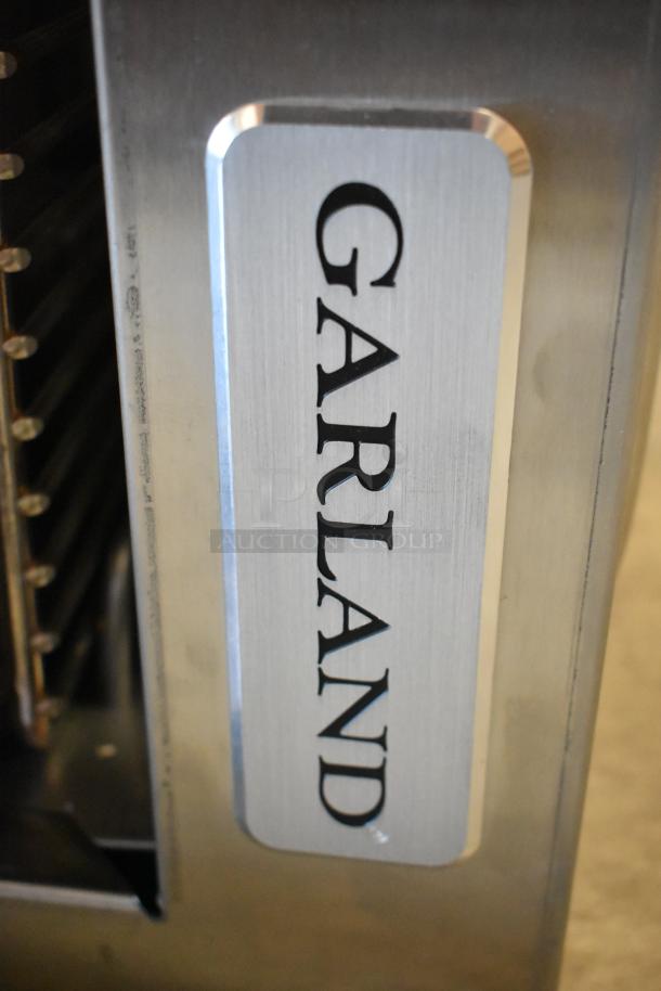 Garland stainless steel salamander cheese melter, natural gas powered, features a back splash. Visible branding.
