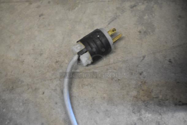 A close-up of a power plug connected to the Bizerba GSP H Meat Slicer, 120 volts, showing intact condition.