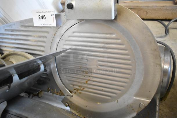 Hobart 1612E metal commercial meat slicer with blade sharpener, 120 volts, 1 phase. Some visible wear; auction tag 246.
