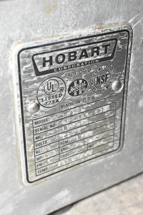 Hobart 1612E metal commercial meat slicer, features blade sharpener, 120V, 1 phase; includes model and serial number plate.