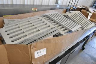 Box of Cambro gray poly Metro shelf pieces, new condition, multiple slatted panels in a cardboard box, auction label 249.