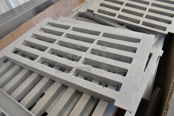 Box of Cambro gray poly Metro shelf pieces, used condition, durable, lattice design, suitable for shelving units.