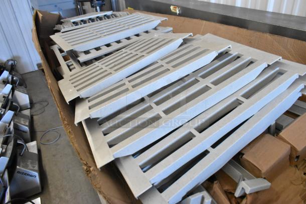Box of Cambro gray poly Metro shelf pieces, new condition, slotted design for ventilation, ideal for kitchen shelving.