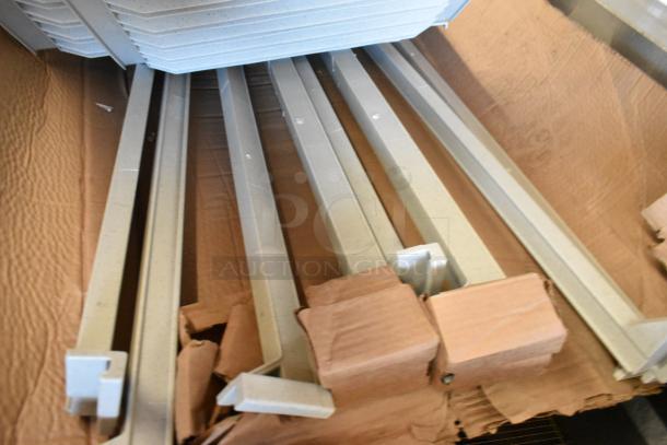 Box of Cambro gray poly Metro shelf pieces, new condition, showing sturdy and uniform construction, ideal for shelving systems.