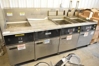 Giles EOF stainless steel commercial electric 3-bay deep fat fryer with dumping station, on casters, 480 volts, with caution labels.