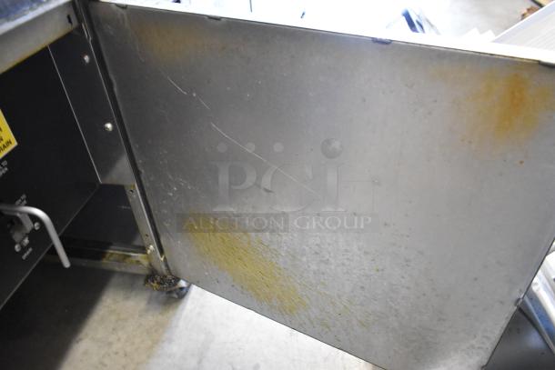 Giles EOF stainless steel 3-bay deep fat fryer with dumping station, on commercial casters. Shows signs of use. 480 volts.