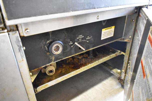 Giles EOF stainless steel 3-bay deep fat fryer with dumping station, showing pump discharge controls and caution labels.