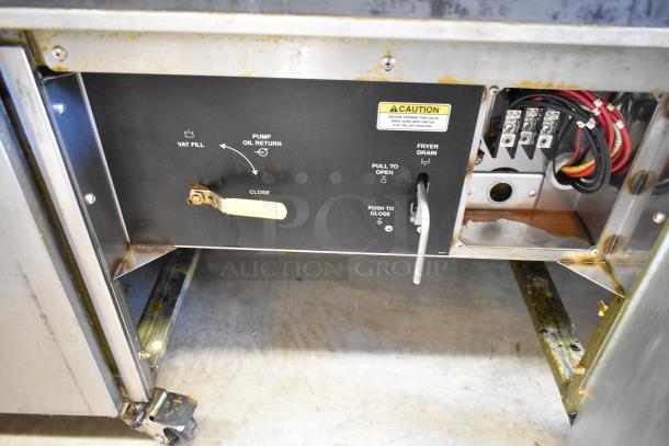 Giles EOF stainless steel 3-bay deep fat fryer, electric, with dumping station on casters. Features vat fill, pump oil return, and fryer drain controls. 480 volts.