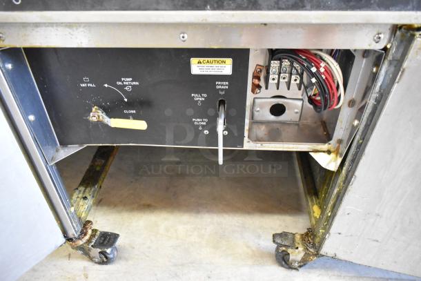 Giles EOF Stainless Steel 3 Bay Deep Fat Fryer with dumping station and commercial casters, 480 volts, showing control panel and wiring.