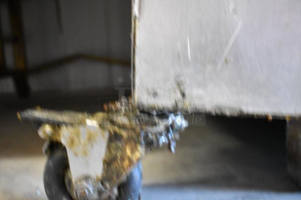 Giles EOF 3-bay deep fat fryer with dumping station on casters, 480V, stainless steel. Visible wear, caster detail shown.