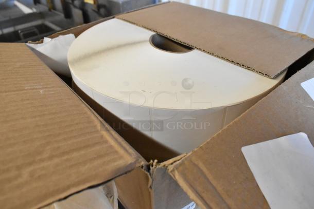 52 sealed boxes of 2 rolls each, 3"x3" TCDT-BLANK labels, showcasing one open box with rolls inside.