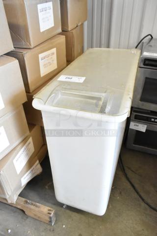 White poly ingredient bin on commercial casters, durable, with lid, used condition, ideal for kitchen storage.