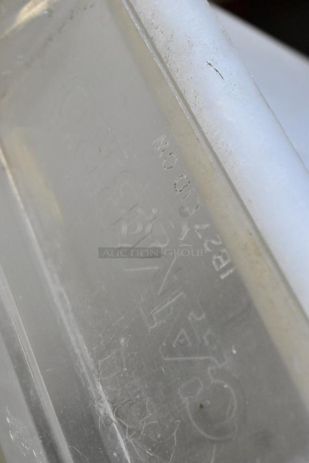 White poly ingredient bin with commercial casters, visible embossed markings, showing signs of wear. Ideal for storage use.