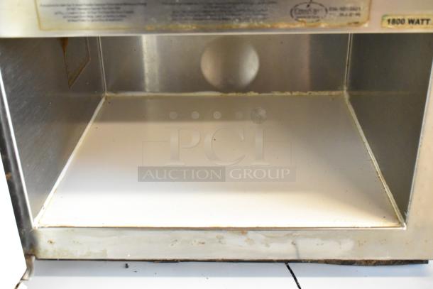 Menumaster MDC182 stainless steel commercial countertop microwave oven, interior view, showing signs of wear. 208/230 volts, 1 phase.
