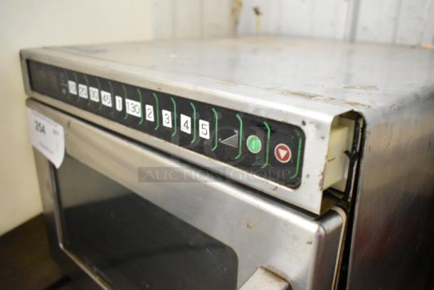 Menumaster MDC182 commercial microwave oven, stainless steel, countertop model, worn condition, visible controls, 208/230V.