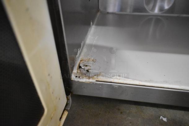 Menumaster MDC182 stainless steel commercial microwave, interior shows significant wear and rust in lower corner.
