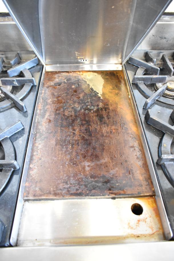 Wolf Gourmet stainless steel gas range with 4 burners, center flat top, and convection oven. Used condition; visible wear.