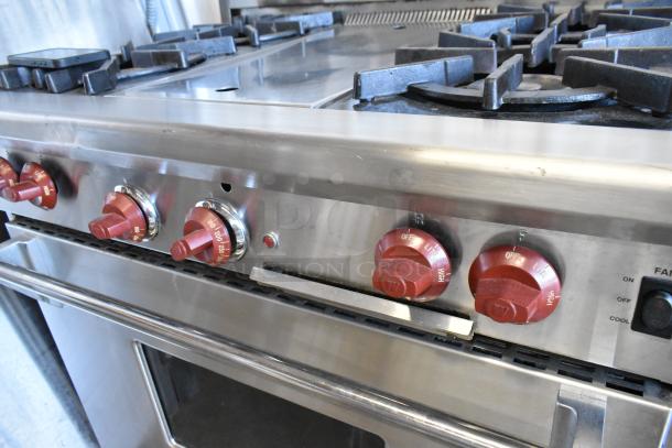 Wolf Gourmet stainless steel commercial gas range with 4 burners, center flat top, convection oven, red knobs, excellent condition.