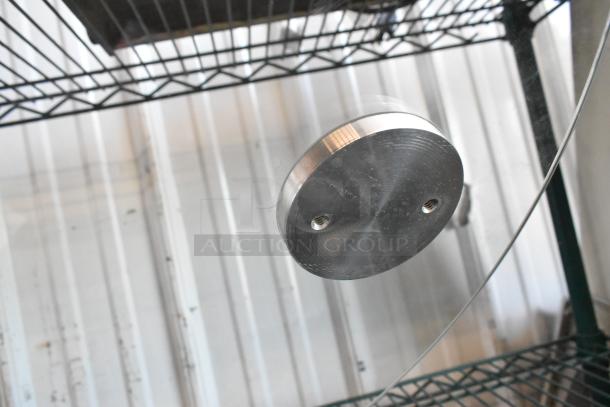 Round glass pane with metallic mounting fixture, shows two screw holes. Clear and reflective, used condition.