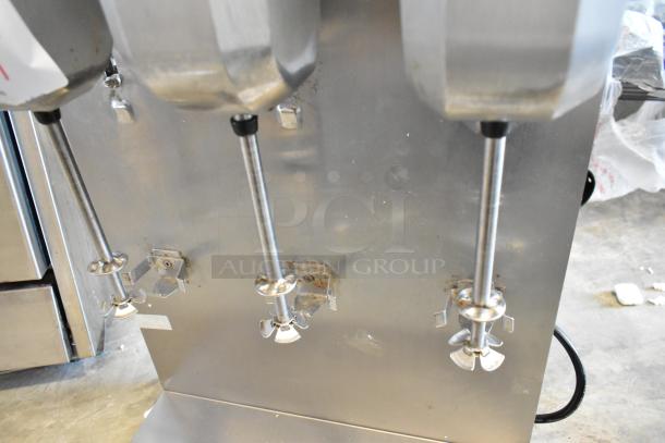Waring DMC201DCA stainless steel countertop drink mixer with 3 heads, 120V, 1 Phase, visible wear, sturdy construction.