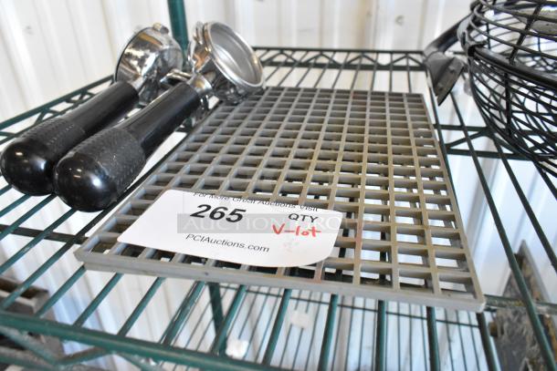 Lot of espresso machine items including portafilters on metal shelf. Label shows auction number 265, quantity marked as V-lot.