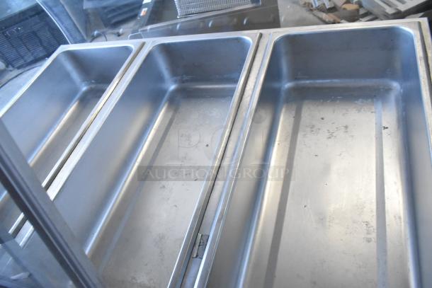 Federal Industries SN4HD commercial refrigerated display case. Metal construction, three compartments, suitable for showcasing items.