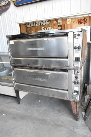 Blodgett 1201-R stainless steel single deck electric pizza oven, worn condition, with cooking stones and metal legs.