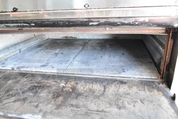 Blodgett 1201-R stainless steel commercial pizza oven, cooking stones, on metal legs. 230-240 Volts, 1 Phase. Signs of use.