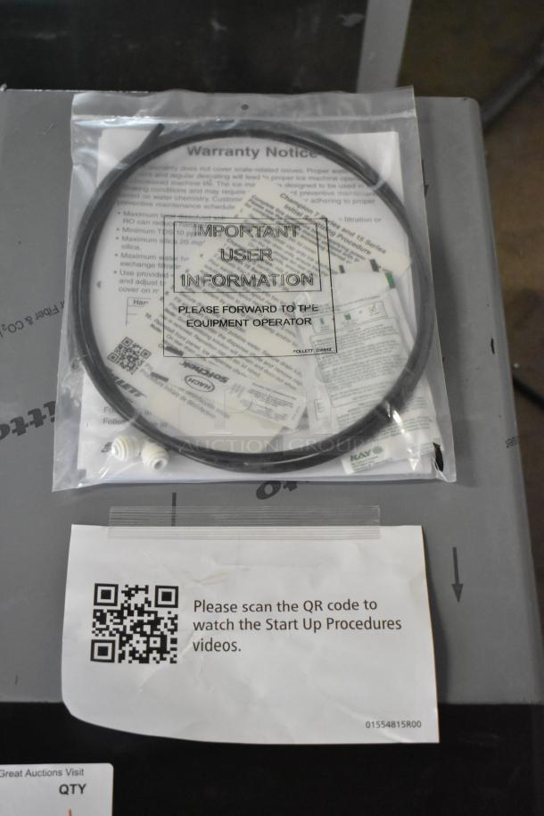 Follett 7CI112A-IW-NF-ST-00 Ice Maker/Dispenser with manual and QR code instructions on top.