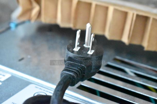 Power cord of a Follett 7CI112A-IW-NF-ST-00 ice maker, showing a three-prong plug, ready for connection.