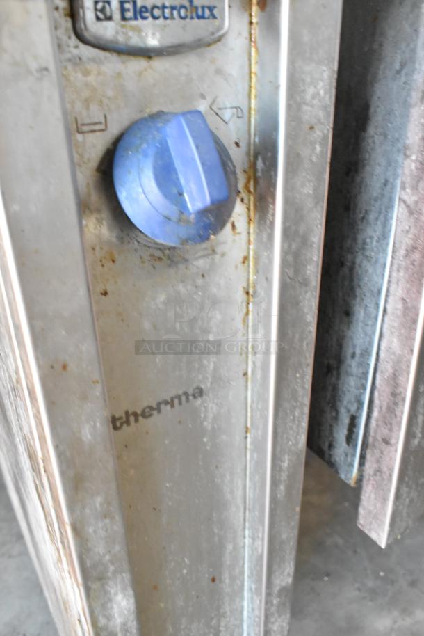 Electrolux stainless steel commercial braising pan with blue control knob, shows wear. Marked "208 Volts, 3 Phase".