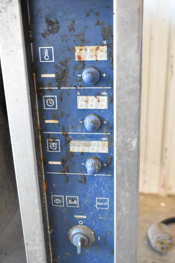 Electrolux commercial braising pan control panel, showing digital displays and dials, stainless steel, some rust visible.