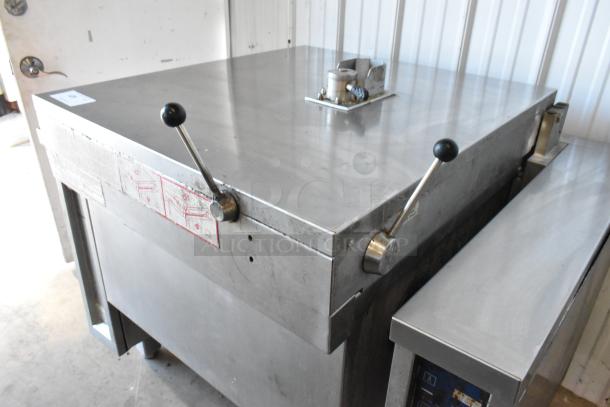Electrolux stainless steel commercial braising pan, floor style, 208 volts, 3 phase; features dual handles, used condition.