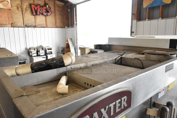 Baxter stainless steel commercial gas rotating rack oven, dual pan rack, on casters, visible wear, includes labels.