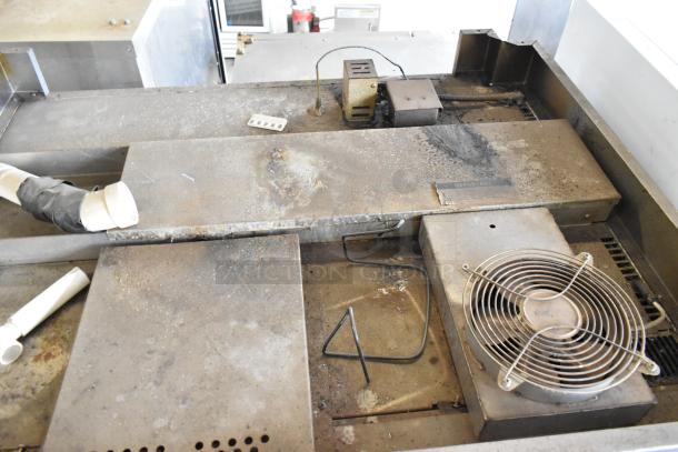 Baxter stainless steel commercial natural gas mini rotating rack oven with dual pan rack, visible wear and dust, on casters.