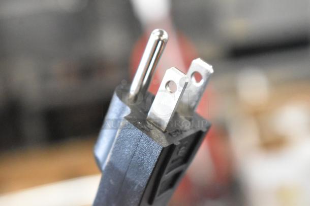 Close-up of AvaMix 928IBHD12 immersion blender power plug, showing prongs and textured casing.