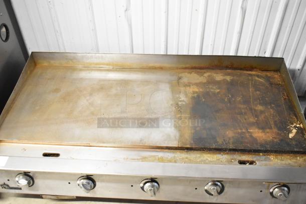 Star Ultra Max stainless steel griddle, natural gas powered, commercial countertop, worn surface, five control knobs.