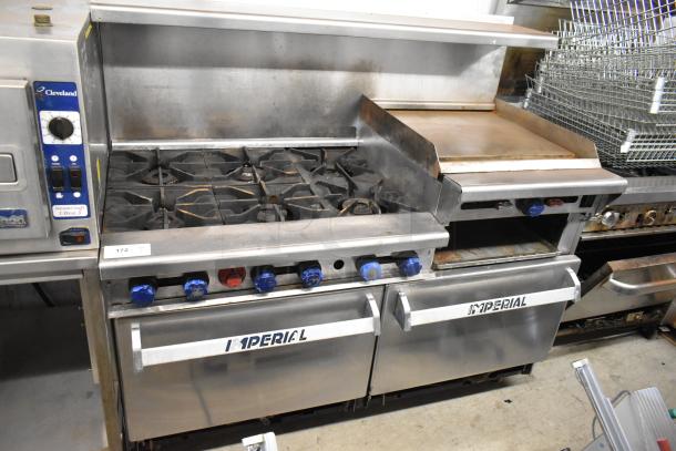 Imperial stainless steel commercial range with 6 burners, right flat top griddle, 2 ovens, over shelf, backsplash, on casters.