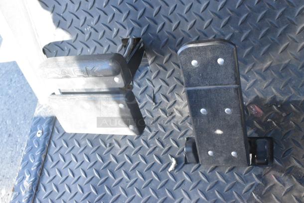 EZ Go golf cart floor pedals on diamond-patterned mat; one pedal labeled "Park."