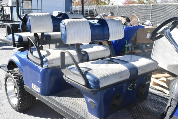 EZ Go 6-seat blue and white golf cart with speaker system, lightly used, showing EZ Go branding, suitable for golf courses.