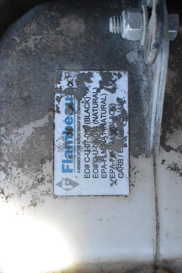 Flambeau label on surface detailing color options: black, natural. Label shows environmental compliance codes.