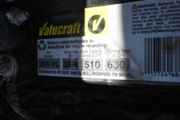 Alt text: Close-up of Valucraft battery label on EZ Go golf cart. Shows part number 26R-VL, group size 26R, and cranking amps of 510 at 0°F and 630 at 32°F.