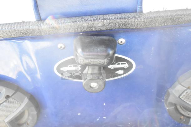 Blue and white 6-seat EZ Go golf cart detail showing gear selector with forward/reverse indicator and integrated speaker system.