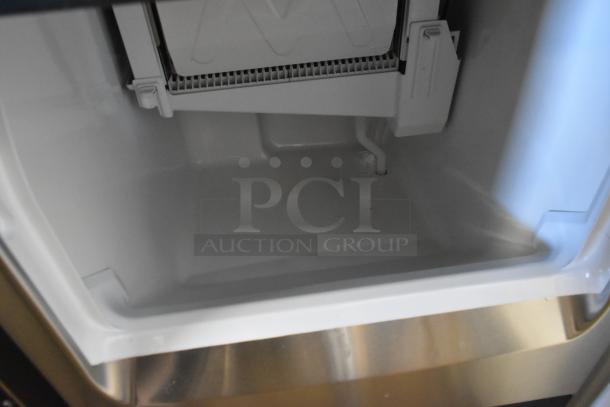 Stainless steel Hoshizaki KM-81BAJ ice machine interior, new condition, with 38 lb. bin, showing ice-making components.