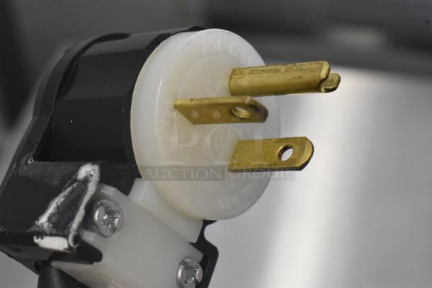 Close-up of the electrical plug of a Hobart LXGNR glass washer, showing a three-prong design, part of the 2025 model.
